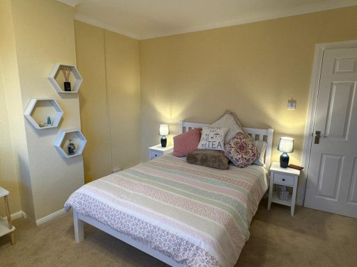 Bedroom in neutral tones with bed in centre